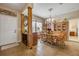 Inviting dining area with wood floors, wooden table and chairs, and elegant china cabinet at 115 Los Arbor Dr, Deland, FL 32724