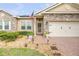 A well-maintained home exterior with brick pathway, stone details, and an American flag at 115 Los Arbor Dr, Deland, FL 32724