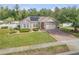 Charming home with stone accents, solar panels, manicured lawn and a brick driveway at 115 Los Arbor Dr, Deland, FL 32724