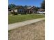Charming single-story home boasts a well-manicured lawn, stone accents, and a two-car garage, offering curb appeal at 115 Los Arbor Dr, Deland, FL 32724