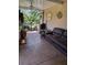 Relaxing screened patio with a comfortable couch and potted plants, great for enjoying the outdoors in comfort at 115 Los Arbor Dr, Deland, FL 32724