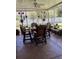 Screened-in patio features a ceiling fan and comfortable seating, ideal for outdoor dining and relaxation at 115 Los Arbor Dr, Deland, FL 32724