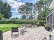 Private backyard featuring a brick patio with a cozy fire pit and comfortable seating at 1156 Rivercrest Ct, Port Orange, FL 32128