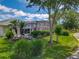 Lush backyard featuring a screened-in lanai and mature landscaping, offering privacy and tranquility at 1156 Rivercrest Ct, Port Orange, FL 32128