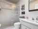 Bright bathroom featuring a tiled shower with glass door and vanity with a decorative mirror at 1156 Rivercrest Ct, Port Orange, FL 32128