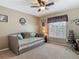 Cozy bedroom with a trundle bed, ceiling fan, and a window letting in plenty of natural light at 1156 Rivercrest Ct, Port Orange, FL 32128