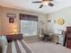 Comfortable bedroom featuring neutral colors, a trundle bed, and a ceiling fan for a relaxing ambiance at 1156 Rivercrest Ct, Port Orange, FL 32128