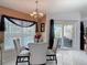Cozy dining area with natural light, stylish chandelier, and access to the outdoor living space at 1156 Rivercrest Ct, Port Orange, FL 32128