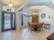 Bright dining room featuring wood table, chandelier, and a window with blinds at 1156 Rivercrest Ct, Port Orange, FL 32128