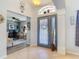 Open foyer with tile flooring, transom window, and views into the office at 1156 Rivercrest Ct, Port Orange, FL 32128