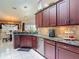 Modern kitchen boasts granite countertops, stainless steel appliances, and ample cabinet space at 1156 Rivercrest Ct, Port Orange, FL 32128