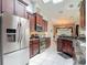 Bright kitchen featuring stainless steel appliances, granite countertops, and convenient access to the dining area at 1156 Rivercrest Ct, Port Orange, FL 32128