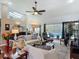 Bright living room with skylights, ceiling fan, and sliding glass doors to the pool area at 1156 Rivercrest Ct, Port Orange, FL 32128