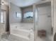 Relaxing main bathroom with a large soaking tub, glass-enclosed shower, and serene decor at 1156 Rivercrest Ct, Port Orange, FL 32128