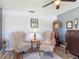 Comfortable office area with two striped chairs, a grandfather clock, and ample decor at 1156 Rivercrest Ct, Port Orange, FL 32128