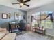Well-lit office with a ceiling fan, desk, decorative accents, and a large window at 1156 Rivercrest Ct, Port Orange, FL 32128