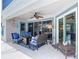 Relaxing covered patio with comfortable seating, a ceiling fan, and stylish decor accents at 1156 Rivercrest Ct, Port Orange, FL 32128