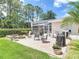 Charming patio area with a fire pit, grill, and comfortable seating, perfect for relaxing and entertaining outdoors at 1156 Rivercrest Ct, Port Orange, FL 32128