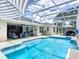 Beautiful pool area with seating, a striped awning, and access to the covered patio at 1156 Rivercrest Ct, Port Orange, FL 32128