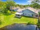Aerial view of a home showcasing a screened-in porch and peaceful pond views from the backyard at 116 Duck Hawk Cir # 3040, Daytona Beach, FL 32119