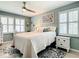 Bedroom with light green walls, ceiling fan, and carpet; large window provides natural light at 116 Duck Hawk Cir # 3040, Daytona Beach, FL 32119