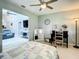 Serene bedroom showcasing a cozy bed, a dark desk, and a view of the adjacent living room at 116 Duck Hawk Cir # 3040, Daytona Beach, FL 32119