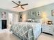 Bedroom with light green walls, ceiling fan, and decorative wall art and accessories at 116 Duck Hawk Cir # 3040, Daytona Beach, FL 32119
