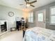 Comfortable bedroom with a desk area, ceiling fan, and door to the outside at 116 Duck Hawk Cir # 3040, Daytona Beach, FL 32119