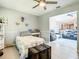 Bright bedroom with a comfortable bed, vintage trunk, and a glimpse into the adjacent living area at 116 Duck Hawk Cir # 3040, Daytona Beach, FL 32119