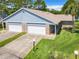 Charming exterior showcasing a two-car garage and well-maintained lawn at 116 Duck Hawk Cir # 3040, Daytona Beach, FL 32119