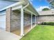 Inviting front porch with brick facade and manicured lawn at 116 Duck Hawk Cir # 3040, Daytona Beach, FL 32119