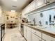 Bright kitchen features white cabinets and stainless steel appliances at 116 Duck Hawk Cir # 3040, Daytona Beach, FL 32119