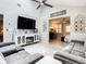 Cozy living room with plush seating, a modern entertainment center, and access to an adjacent bedroom at 116 Duck Hawk Cir # 3040, Daytona Beach, FL 32119