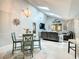 Open-concept living room featuring a dining area with modern decor, skylights, and comfortable seating at 116 Duck Hawk Cir # 3040, Daytona Beach, FL 32119