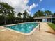 Relaxing community pool surrounded by lush greenery and a charming pool house at 116 Duck Hawk Cir # 3040, Daytona Beach, FL 32119