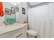 Well-lit bathroom featuring a marble vanity, sleek fixtures and tiled wall at 13 Essex Dr, Ormond Beach, FL 32176