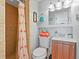 Cozy bathroom featuring a tiled shower, a flamingo shower curtain, and a modern vanity at 13 Essex Dr, Ormond Beach, FL 32176