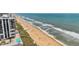 Scenic beach view featuring oceanfront condo, sandy beach, and turquoise ocean water at 13 Essex Dr, Ormond Beach, FL 32176