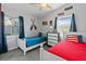 Comfortable bedroom featuring twin beds, patriotic accents, and natural light at 13 Essex Dr, Ormond Beach, FL 32176