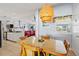 Bright dining area with a bamboo table and chairs adjacent to the kitchen and living room at 13 Essex Dr, Ormond Beach, FL 32176