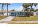 Charming single-story home with a well-maintained lawn, palm trees, and a covered entryway at 13 Essex Dr, Ormond Beach, FL 32176
