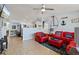Cozy living room with tiled floors, a ceiling fan, and nautical-themed décor at 13 Essex Dr, Ormond Beach, FL 32176