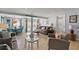 Bright living room with tile flooring, comfortable seating, and a view of the outdoor pool area at 13 Essex Dr, Ormond Beach, FL 32176