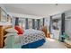 Bright main bedroom with a large bed, multiple windows, and access to the outdoor space at 13 Essex Dr, Ormond Beach, FL 32176