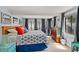 Sunlit main bedroom with a large bed, multiple windows, and coastal-themed decor at 13 Essex Dr, Ormond Beach, FL 32176