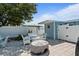 Cozy backyard seating area with white wicker furniture and a fire pit at 13 Essex Dr, Ormond Beach, FL 32176