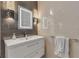 Sleek bathroom sink featuring modern lighting and a crisp white sink and cabinet combo at 133 Via Capri, New Smyrna Beach, FL 32169