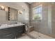 Modern bathroom featuring a stylish vanity and a glass-enclosed shower with sleek fixtures and a built-in bench at 133 Via Capri, New Smyrna Beach, FL 32169