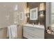 Modern bathroom features a sleek vanity, illuminated mirror, and stylish fixtures, creating a spa-like atmosphere at 133 Via Capri, New Smyrna Beach, FL 32169