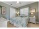 Charming bedroom features a bed, side tables with lamps, and a light green wall, offering a comfortable retreat at 133 Via Capri, New Smyrna Beach, FL 32169